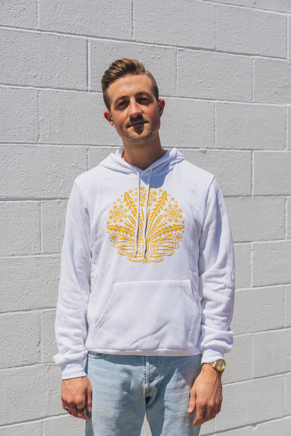 man wearing white hoodie with gold little brother dandelion logo on front