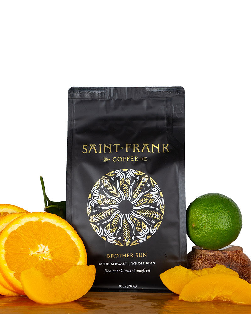Brother Sun coffee bag surrounded by Oranges, Apricots, and Lime