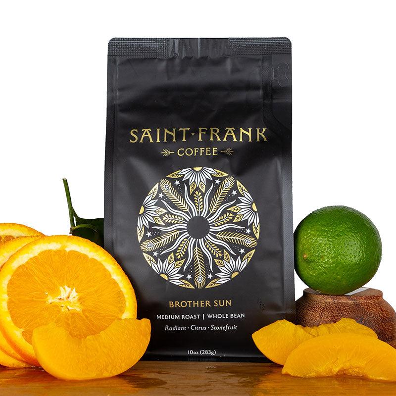 Brother Sun coffee bag surrounded by Oranges, Apricots, and Lime