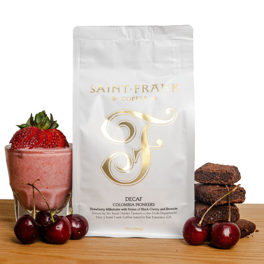 Decaf coffee bag surrounded by Cherries, Brownie, and Strawberry Milkshake