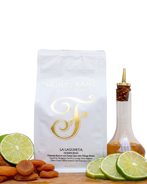 Coffee bag surrounded by Dried Apricot, Lime, and Orange Bitters